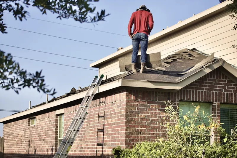 Professional roofer working on a residential roof in Shelby